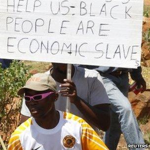 Striking miners arrive for their gathering at the AngloGold Ashanti mine in Carletonville, north-west of Johannesburg 19 October, 2012