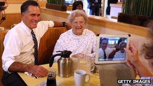 Mitt Romney sits with patrons at First Watch Cafe on 25 October 2012 in Cincinnati, Ohio