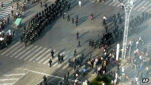 Police officers prepare to disperse people gathered on a street at Zhenhai district in Ningbo city on Saturday, 27 October.