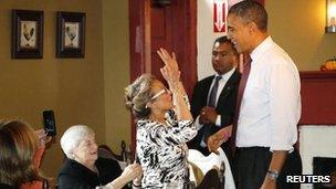 Barack Obama greets a diner in a restaurant in Merrimack, New Hampshire 27 Oct