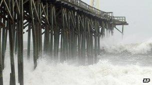 Waves pound Carolina Beach pier in Carolina Beach, N.C., Saturday, Oct 27,