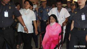 Former Philippine President Gloria Macapagal Arroyo, now a sitting lawmaker in the lower house of Congress, sits on a wheelchair on her way towards the Sandiganbayan anti-graft court in Quezon City, Metro Manila 29 October, 2012