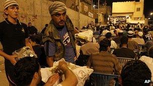 Jihadists hand out sweets during memorial service for "martyr" in Baqaa. 22 Sept 2012