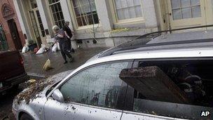 Two women clean up debris from Hurricane Sandy in New York's South Street Seaport