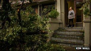 Woman looking at a fallen tree in front of her house, New York City, 30 Oct 2012, Photo: Kim Wall