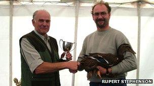 Graham Hicks receives a trophy for his best in show duck