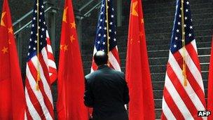 An official adjusting US and China flags