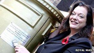 Lyn Brown MP and golden postbox plaque in Stratford