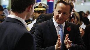 David Cameron gestures while speaking at a fair in Dubai