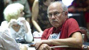 A Romney supporter in Florida watches as reports show Obama won