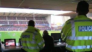 Police officers watching a football game