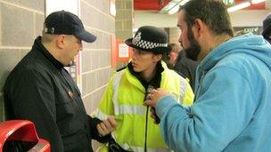 Police officer talking to football fans