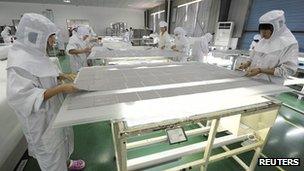 Solar panels being assembled at a factory in China