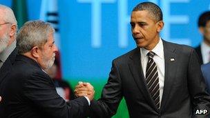 Luiz Inacio Lula da Silva, then Brazil's president, shakes hands with President Obama