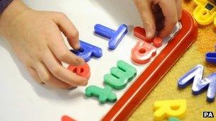 Child playing with letters