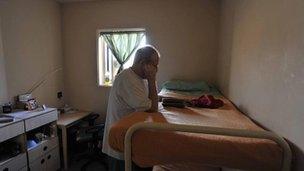 Prisoner reading in cell