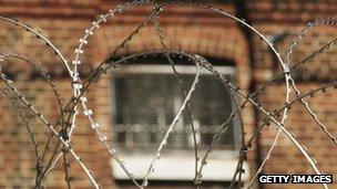 Prison window behind barbed wire