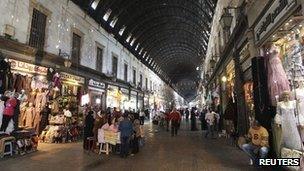Shoppers walk in the al-Hamidieh Souk in the old city of Damascus, 8 November 2012