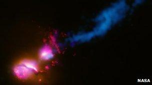 A powerful jet from a supermassive black hole blasts a nearby galaxy