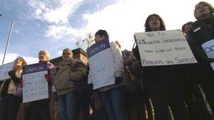 Female hospital workers holding placards in protest