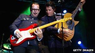 Kirk Pengilly and the new lead singer for INXS Ciaran Gribbin perform on stage at the Perth 2011 Worlds Village on Esplanade Park in 2011.