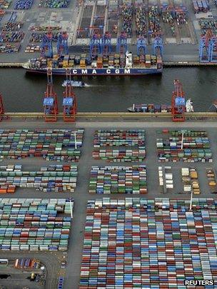 Container ship being loaded at a terminal in the harbour of Hamburg