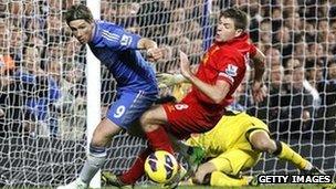 Fernando Torres of Chelsea in action against Liverpool's Steven Gerrard