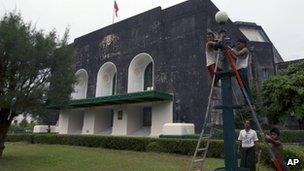 Workers repairing light fixtures outside Rangoon University's Convocation Hall, 15 November 2012