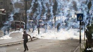 Youth runs away from tear gas fired in Bethlehem clashes