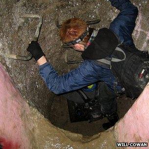 A man descends an underground ladder in Paris