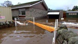 Flood water around a house in Comrie