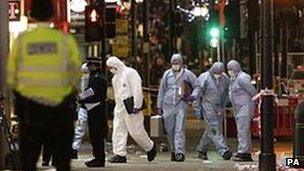 A general view of police at the scene on Oxford Street where a man was stabbed to death