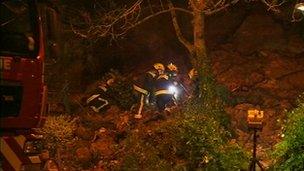 Fire crews search the rubble