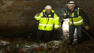 Examining rubble left in collapsed Neburn Culvert