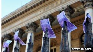 Fake euro notes placed by strikers on the gates outside the Paris Stock Exchange in November 2011