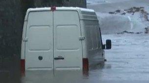 A van stuck in floodwater at Llanrug