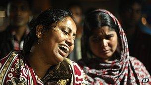Bangladeshi women react outside the clothes factory