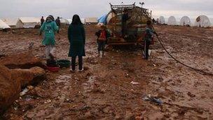 Internally displaced Syrians at a water source in the Atma refugee camp in northern Syria