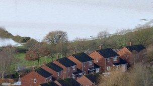 Flood water in fields behind homes