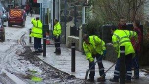 Workmen clearing up after flooding