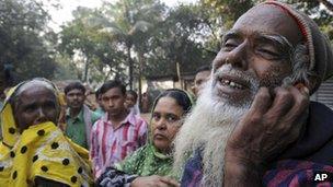 A father mourns as he looks for the body of his son outside the Tazreen factory