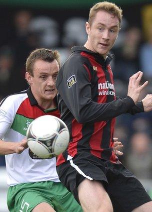 Glentoran's Jason Hill in action against Crusaders striker Timmy Adamson