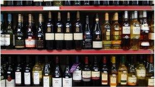 Rows of bottle on supermarket shelf