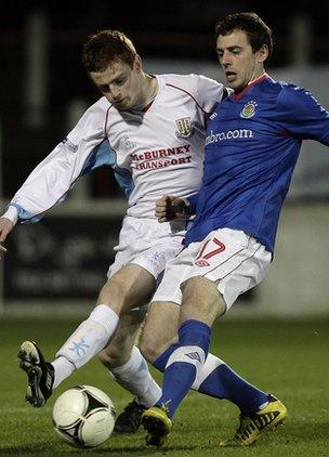 Aaron Stewart of Ballymena battles for possession with Linfield's Gary Browne