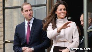 Catherine, Duchess of Cambridge and Prince William, Duke of Cambridge smile and wave to the crowds from the balcony of Cambridge Guildhall as they pay an official visit to Cambridge on November 28, 2012 in Cambridge, England.