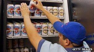 Ambev beer brands being loaded into a fridge at a bar in Rio de Janeiro