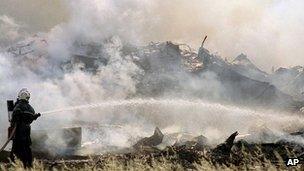 A firefighter sprays water on the debris of an Air France Concorde plane after it crashed into a hotel shortly after take off in Gonesse, France, near Paris (archive image from 25 July 2000)