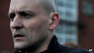 Sergei Udaltsov emerges from the Investigative Committee building in Moscow after being charged, 26 October