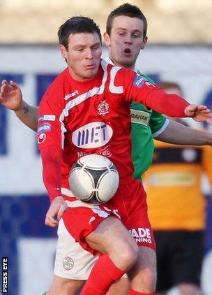 Portadown's Kevin Braniff shields the ball from Cliftonville opponent Jamie McGovern