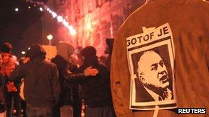 A protester wears a picture of Maribor's Mayor Franc Kangler, which reads: "You are finished", during a demonstration in Maribor December 3, 2012.